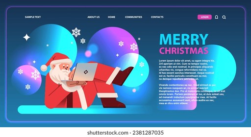 santa claus in red costume lying on his back and typing on laptop happy new year merry christmas holidays celebration concept