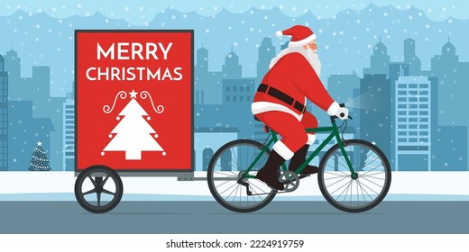 Santa Claus riding a bicycle with trailer advertising in the city street, copy space with Christmas wishes