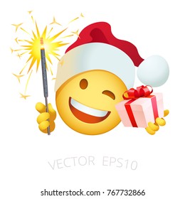 Santa Claus smiley holds a firing sparkler and pink gift box with a red bow. Vector Xmas emoji with a yellow head in the red winter hat. Isolated emoticon of New Years's character winks and laughs.