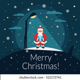 Santa Claus stands with a gift in the hands of the night under a street lamp. Merry Christmas and Happy New Year. Vector.