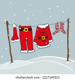 
Santa Claus suit hanged on a clothes line during snow 