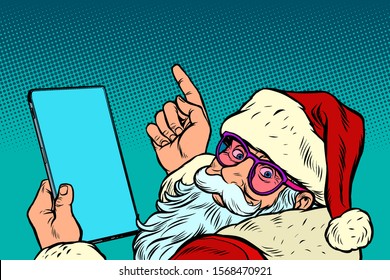 Santa Claus with a tablet. merry Christmas and happy new year. New year and Christmas online sales concept. Pop art retro vector illustration vintage kitsch drawing 50s 60s