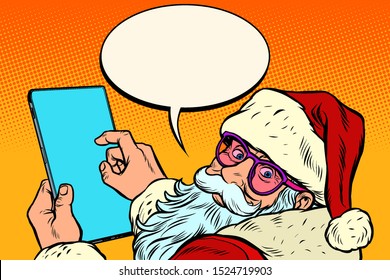 Santa Claus with a tablet. New year and Christmas online sales concept. merry Christmas and happy new year. Pop art retro vector illustration vintage kitsch drawing 50s 60s