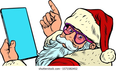 Santa Claus with a tablet. New year and Christmas online sales concept. merry Christmas and happy new year. Pop art retro vector illustration vintage kitsch drawing 50s 60s