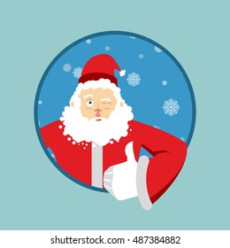 Santa Claus thumbs up well and winks. Sign all right. Merry Christmas character. Hand showing ok. Gesture of hand. Good grandfather with beard in red suit. Illustration for new year
