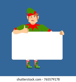 Santa Elf holding banner blank. Christmas helper and white blank. thumb up and winks joyful emotion. place for text. Vector illustration