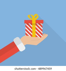 Santa hand holding christmas gift box. Vector illustration