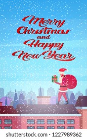 Santa hold gift box stand on roof city building houses winter street cityscape background. Merry Christmas happy new year concept. Flat vertical vector illustration