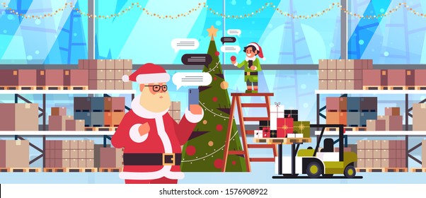 santa with male elf helper chatting using mobile app on smartphone social network chat bubble communication concept modern warehouse interior portrait horizontal vector illustration