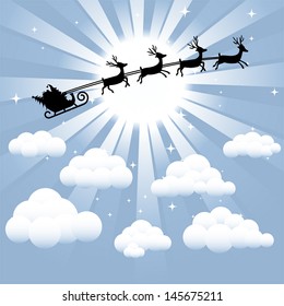 Santa and reindeer silhouette flying through the sky