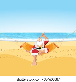 Santa sitting on the tropical beach with shaka sign