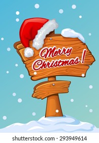 Santa's hat on a wooden pointer with Christmas greetings