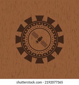 satelite icon inside badge with wooden background. 