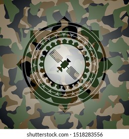 satelite icon inside camouflage emblem