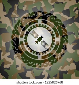 satelite icon inside camouflaged emblem