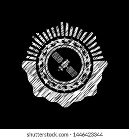 satelite icon inside chalkboard emblem on black board