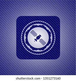 satelite icon inside emblem with denim texture