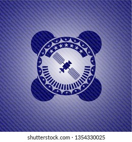 satelite icon inside emblem with denim texture
