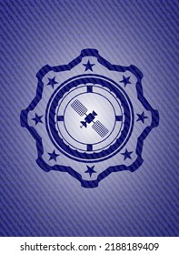 satelite icon inside emblem with denim texture. 