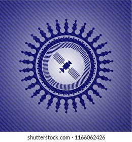 satelite icon inside emblem with jean background