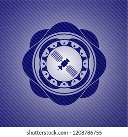 satelite icon inside emblem with jean background
