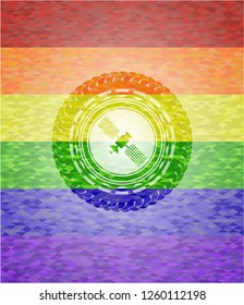 satelite icon inside emblem on mosaic background with the colors of the LGBT flag