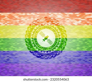 satelite icon inside emblem on mosaic background with the colors of the LGBT flag. 