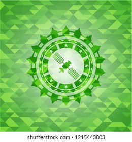 satelite icon inside green emblem. Mosaic background