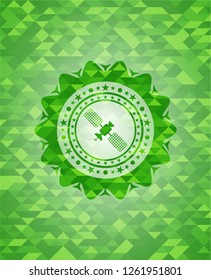 satelite icon inside green emblem with mosaic background