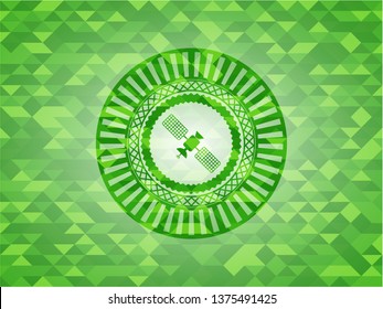 satelite icon inside green emblem. Mosaic background