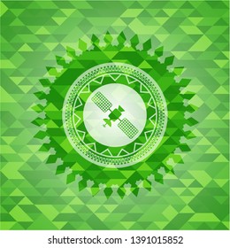 satelite icon inside green emblem with mosaic ecological style background
