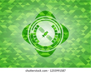 satelite icon inside green mosaic emblem