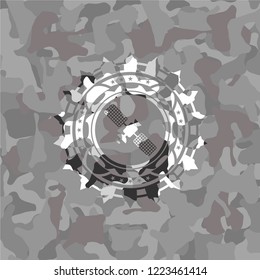 satelite icon inside grey camo emblem