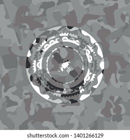 satelite icon inside grey camouflage texture