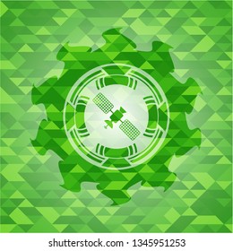 satelite icon inside realistic green mosaic emblem