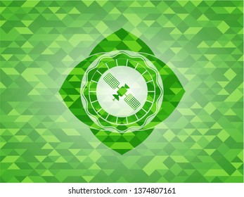 satelite icon inside realistic green mosaic emblem