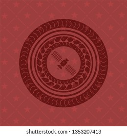 satelite icon inside red emblem