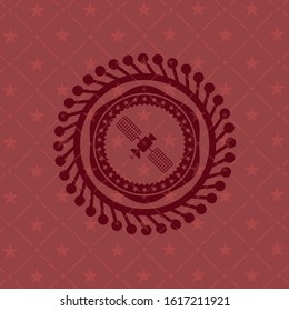 satelite icon inside red emblem