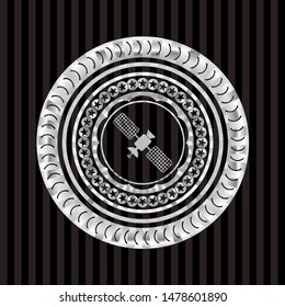 satelite icon inside silver emblem