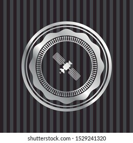 satelite icon inside silvery badge or emblem