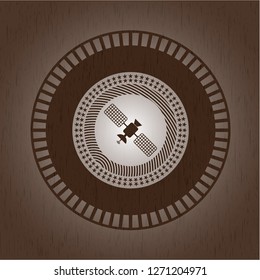 satelite icon inside wood badge or emblem