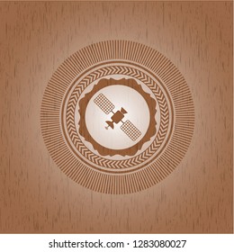 satelite icon inside wooden emblem