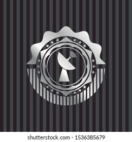 satellite icon inside silver emblem