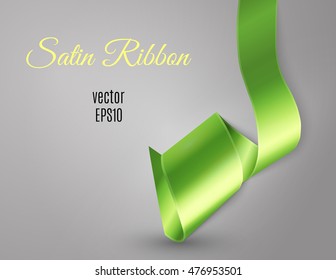 Satin ribbon curl on light grey background and free space for your text