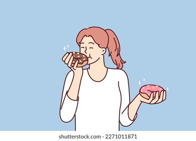 Satisfied beautiful girl eats donuts bought in store with fresh pastries and sweet desserts. Woman eats high-calorie buns covered with sugar icing enjoying donuts from fast food restaurants