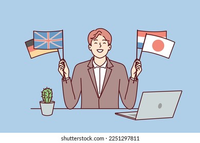 Satisfied man sits at table with laptop and shows flags different countries in solidarity with peoples of world. Positive guy who owns international business or diplomat politician. Flat vector image 