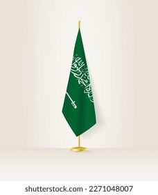 Saudi Arabia flag on a flag stand. Vector illustration.