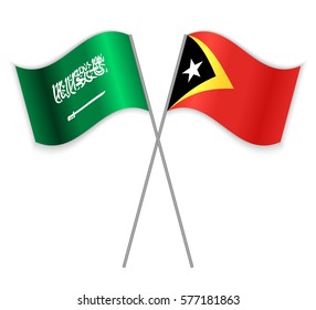 Saudi Arabian and Timorese crossed flags. Saudi Arabia combined with East Timor isolated on white. Language learning, international business or travel concept.