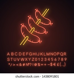 Sausages grilling on skewer neon light icon. Butcher shop, meat. Unhealthy nutrition, fast food. Meat cookery. Glowing sign with alphabet, numbers and symbols. Vector isolated illustration