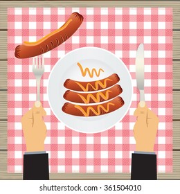 Sausages on a plate and hand with a knife and fork. Sausage, mustard, plate, fork, knife, table. Top view.